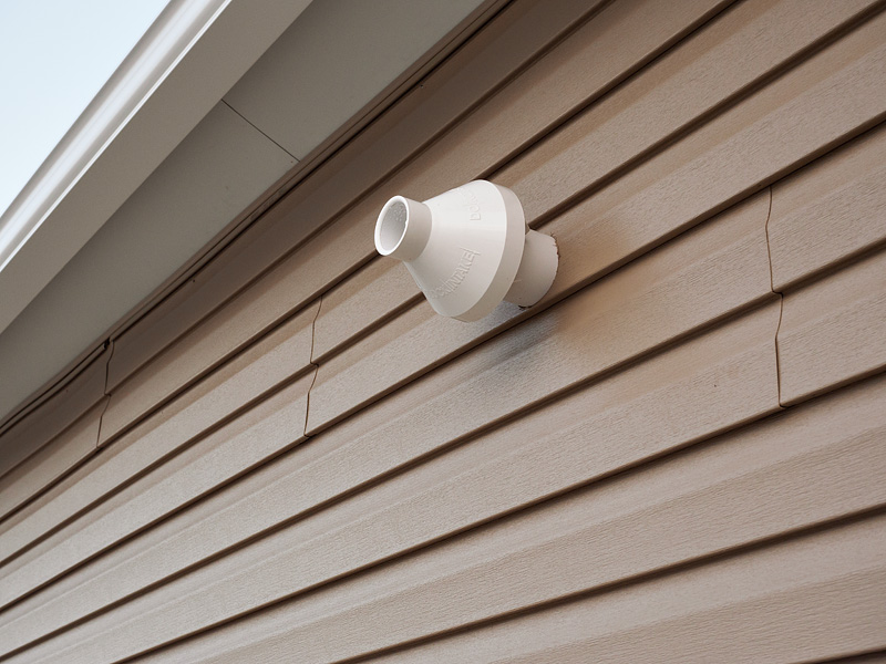 Exhaust vent for a gas furnace on the outside of a building.
